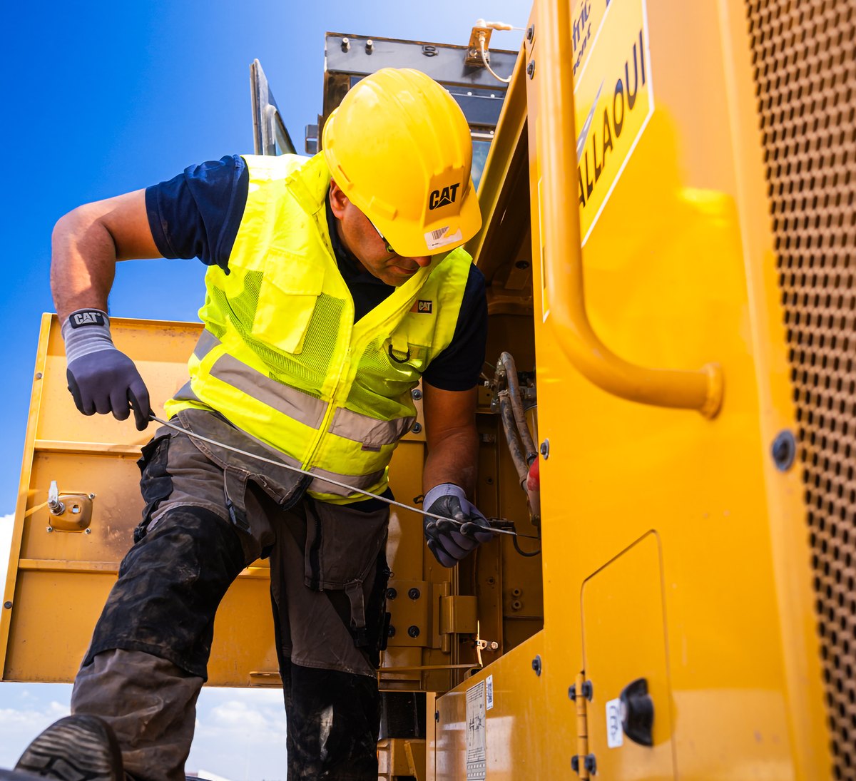 Technician servicing Cat equipment